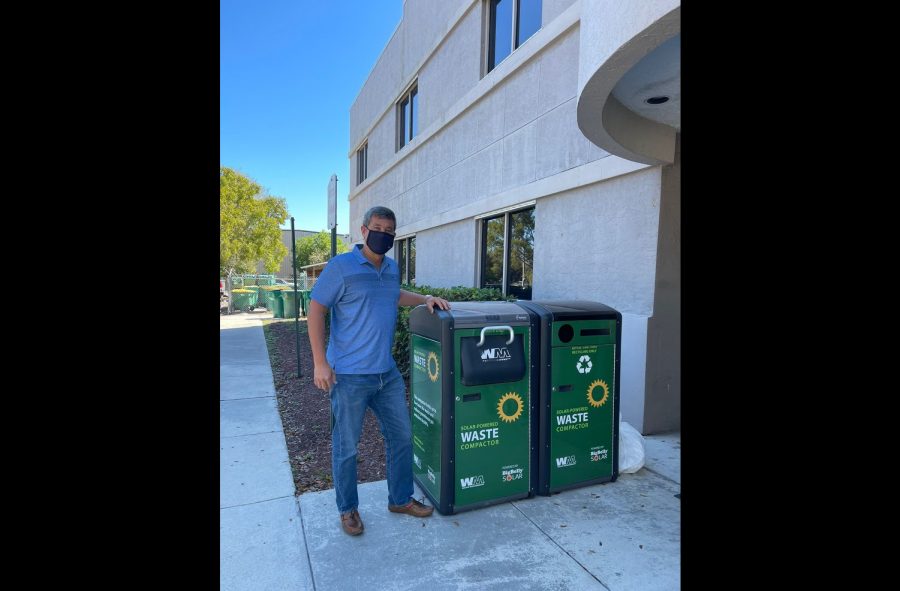 Gruson stands next to BigBelly waste and recycling units. Although recycling is useful, "recyclable does not mean impact-less," he warns, as is still a form of disposal. Consuming less and repairing are better alternatives — that's why "reduce" and "reuse" come before "recycle" in the three Rs.